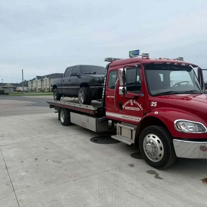 Mike's Wrecker flatbed truck loading a pickup