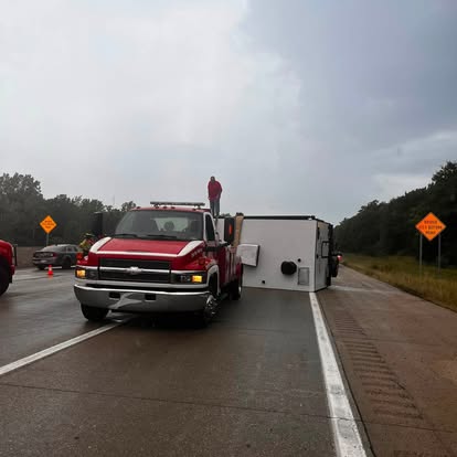 Mike's Wrecker truck towing a camper on the highway