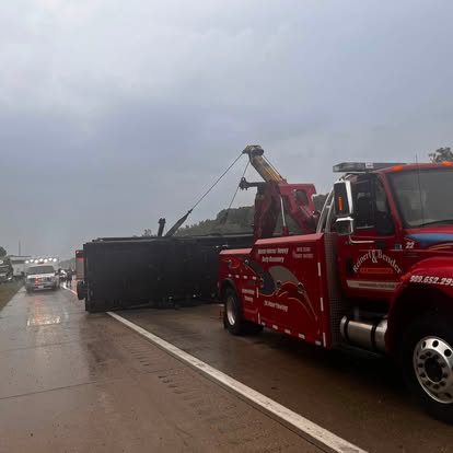 Mike's heavy wrecker recovering an overturned trailer on the highway