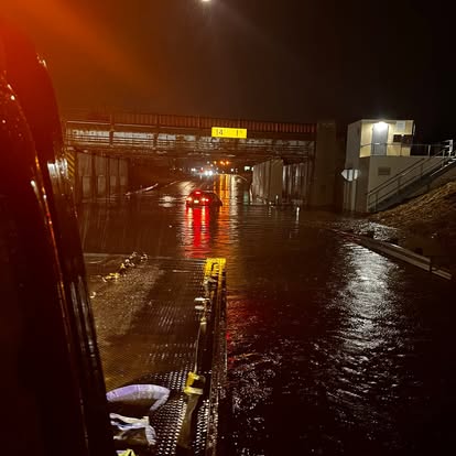 Mike's Wrecker on a call under a flooded overpass at night