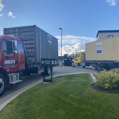 Mike's Wrecker moving containers at a customer yard