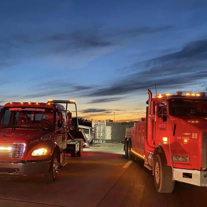 Mike's Wrecker trucks heading out at sunset