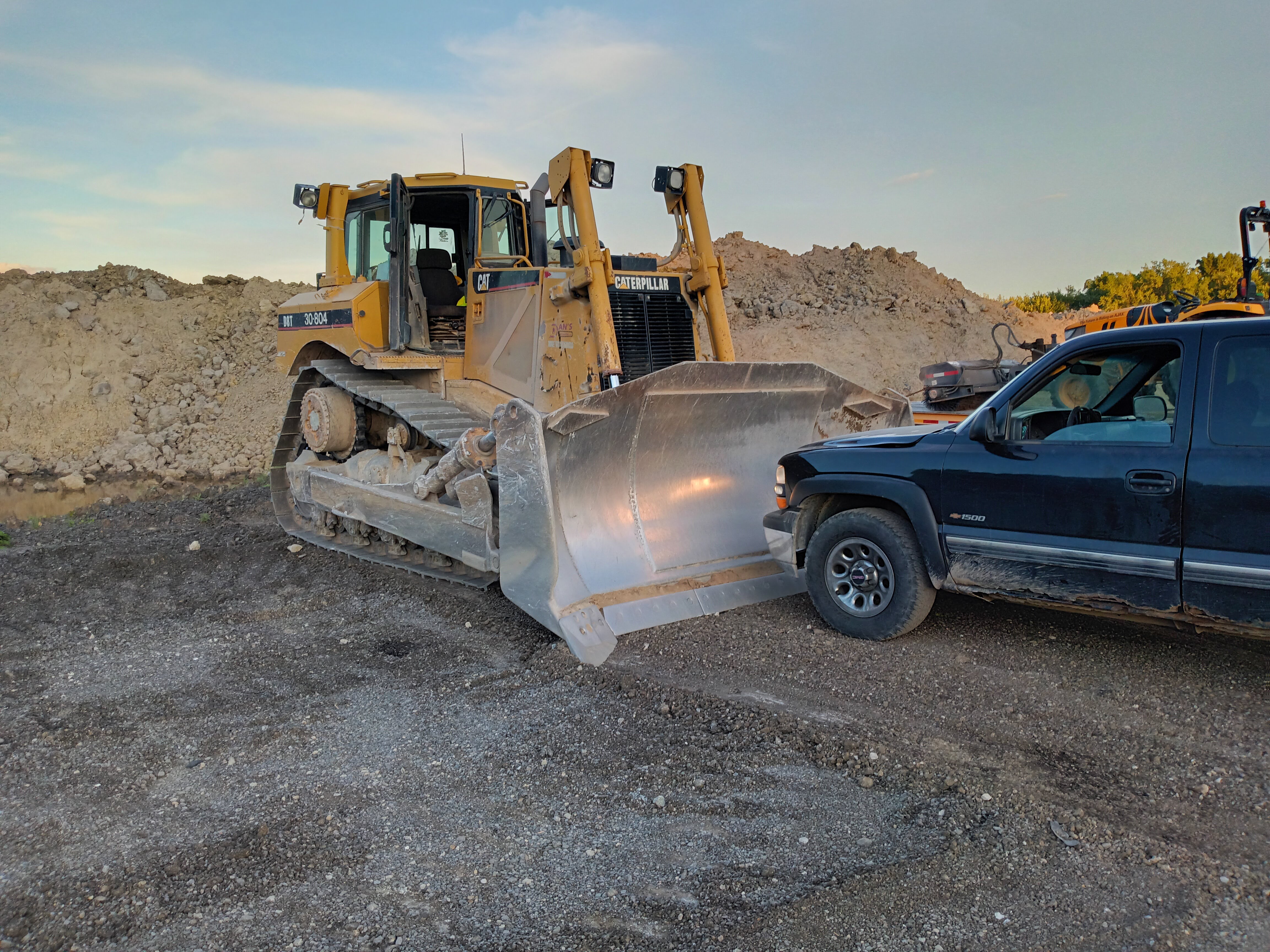 Bulldozer and pickup at a construction site